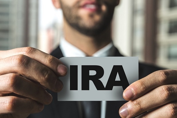 man holding card with IRA on it