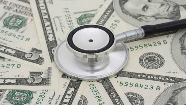 pile of money with stethoscope on top