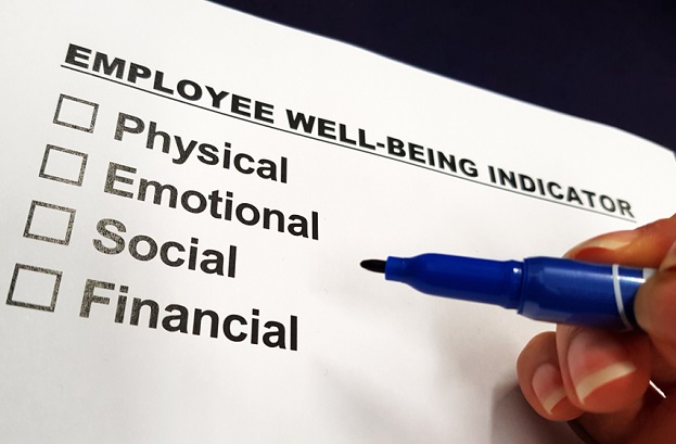 hand with pen hovering over 4 checkboxes under title of employee well being indicators