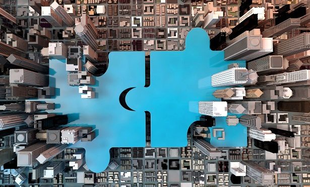 puzzle pieces over background of aerial view of skyscrapers