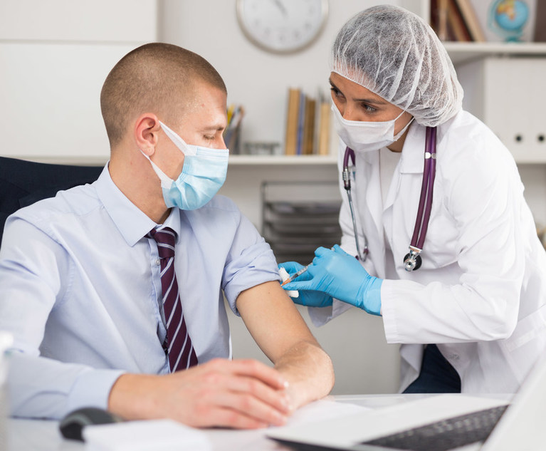 Man getting covid vaccinne from health care professional