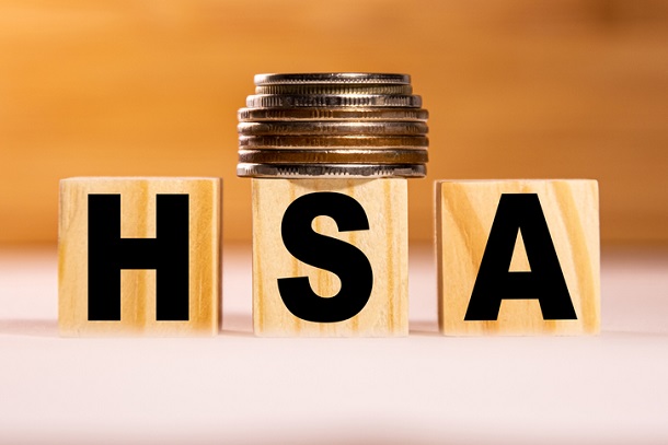 HSA written on wooden blocks with coins on top