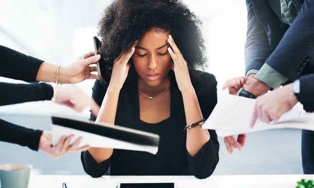 Stressed woman with projects being handed to her