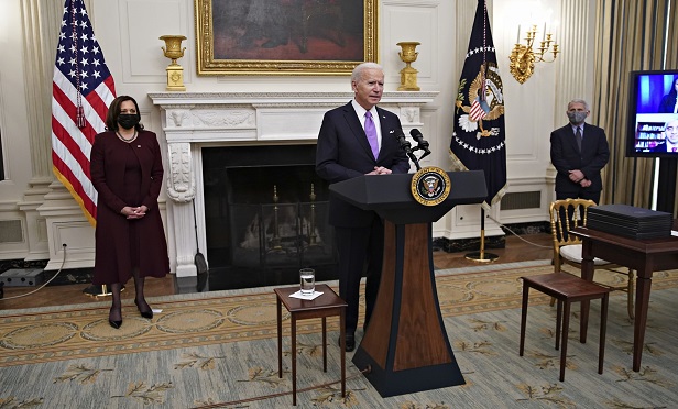 U.S. President Joe Biden speaks as U.S. Vice President Kamala Harris, left, and Anthony Fauci, director of the National Institute of Allergy and Infectious Diseases, right, listen during an event on his administration's Covid-19 response in the State Dining Room of the White House in Washington, D.C., U.S., on Thursday, Jan. 21, 2021. Biden in his first full day in office plans to issue a sweeping set of executive orders to tackle the raging Covid-19 pandemic that will rapidly reverse or refashion many of his predecessor's most heavily criticized policies. Photographer: Al Drago/Bloomberg