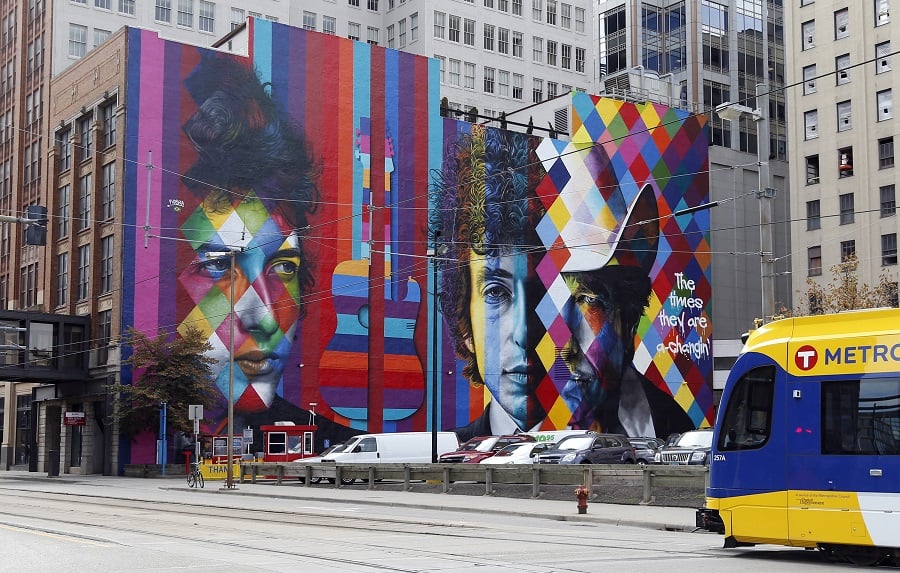 A mural of folk-rock legend and Minnesota native Bob Dylan by Brazilian artist Eduardo Kobra and his team of five artists adorns the wall of a building, Friday, Sept. 11, 2015, in downtown Minneapolis. (AP Photo/Jim Mone)