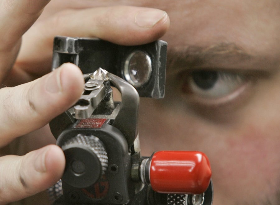 Image of man holding testing device near his eye. Photo: AP