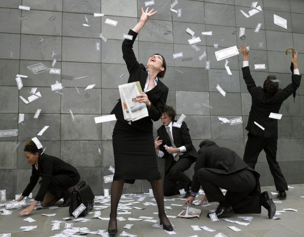People grabbing at flying money