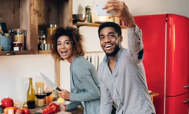 Couple taking selfie while cooking