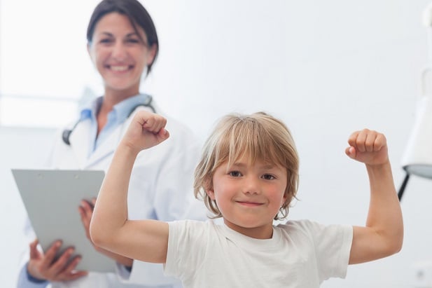 child in victory position, doc smiling