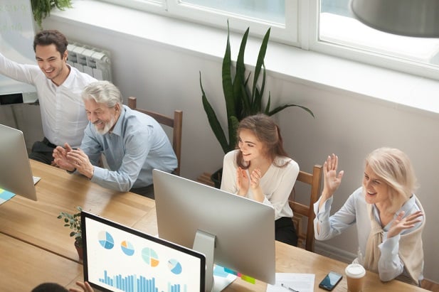 older and younger workers at computers