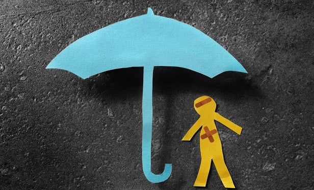 Paper cutout of umbrella and injured person