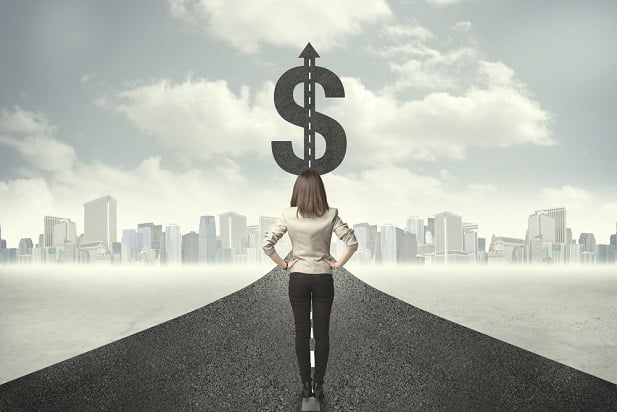 woman looking down a highway with dollar sign at end