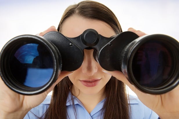 woman looking through binoculars