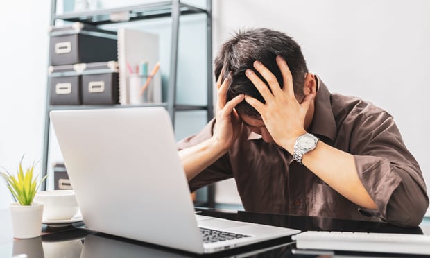 Overwhelmed employee at computer