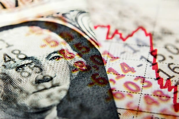 George Washington on dollar bill with falling red stock chart and downward arrow on his face
