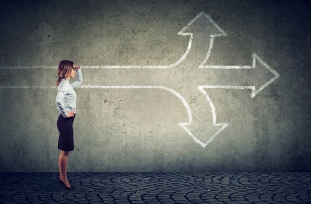 business woman with three arrows on chalkboard pointing in 3 different directions