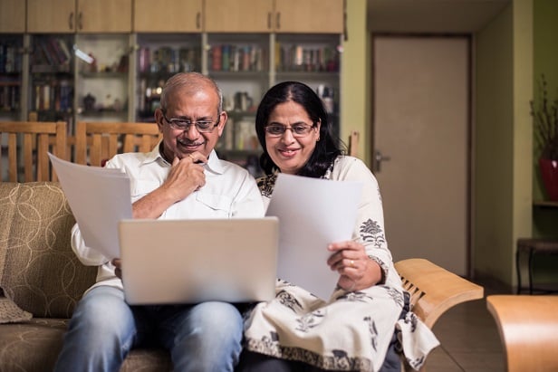 older couple on sofa with laptop looking at files