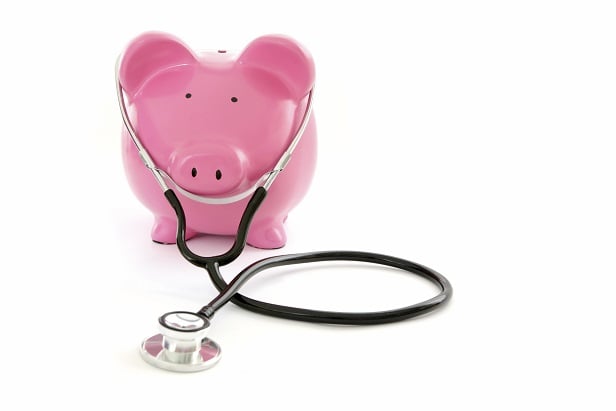 pink piggy bank wearing stethoscope