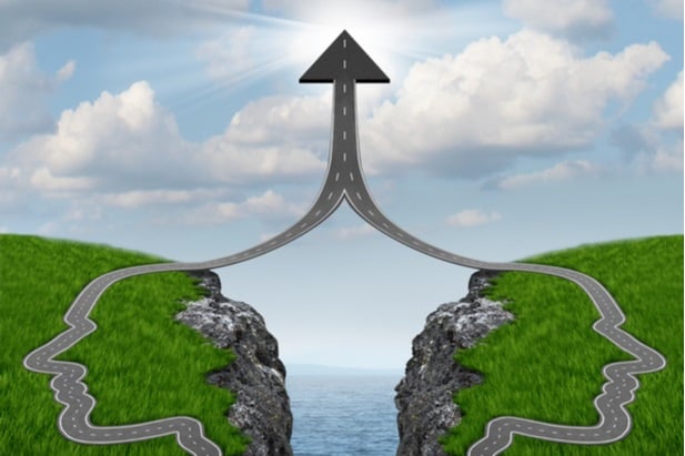 two roads in shape of head silhouettes converging into one upward arrow