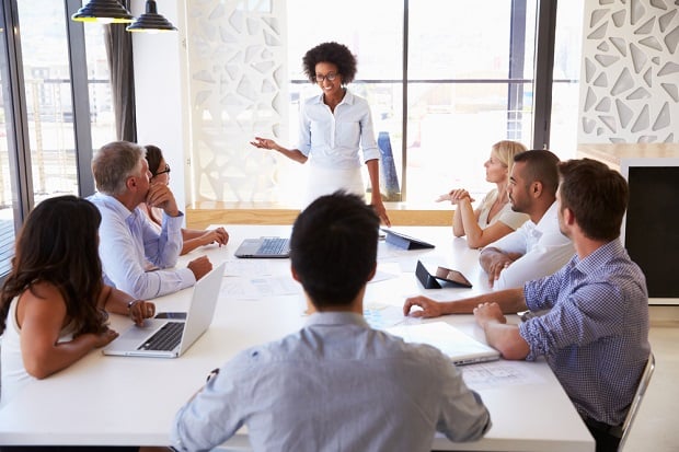 woman giving presentation to small group