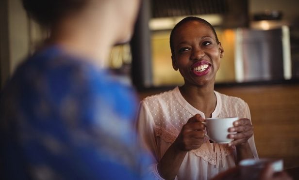 two women talking over coffee