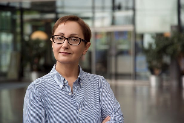 woman with glasses looking at camera