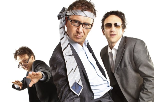 3 men with ties tied around their heads acting silly