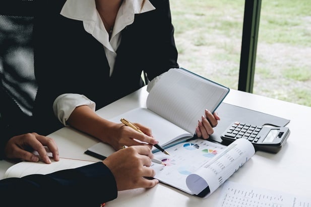 closeup of woman looking at accounts book