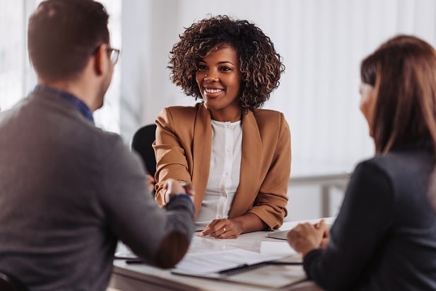 business woman shaking hands with man