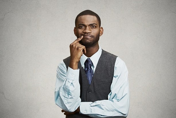 man with crossed arms and hand on chin thinking