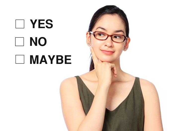 woman looking at three checkboxes marked yes no maybe