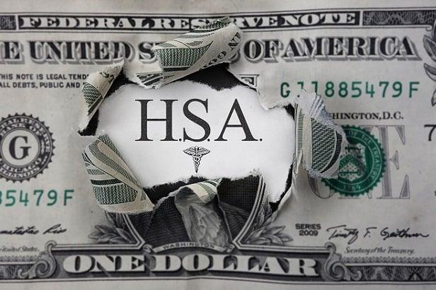 dollar with hole in it and HSA seen through hole