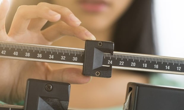 A woman using a scale