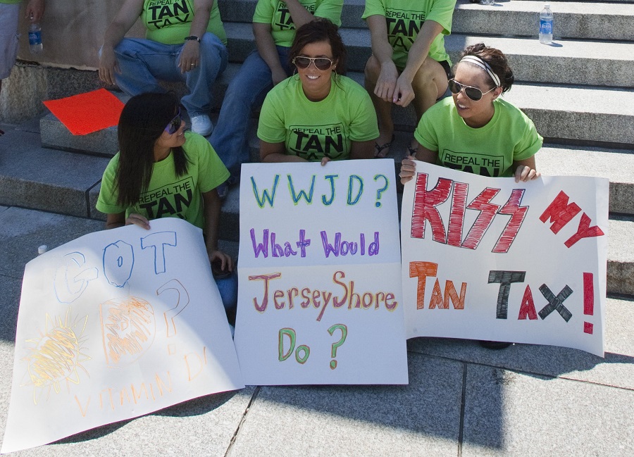 Owners of tanning-bed businesses and their customers sit at the State Capitol in Lincoln, Neb., in 2010, after protesting the 10 percent tax on tanning bed use.(AP Photo/Nati Harnik)