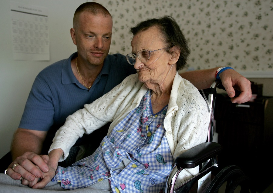 Joe Levesque sits with his 75-year-old mother, Theresa Levesque, at the Wingate nursing home in Haverhill, Mass., Thursday, June 22, 2006. (AP Photo/Steven Senne)