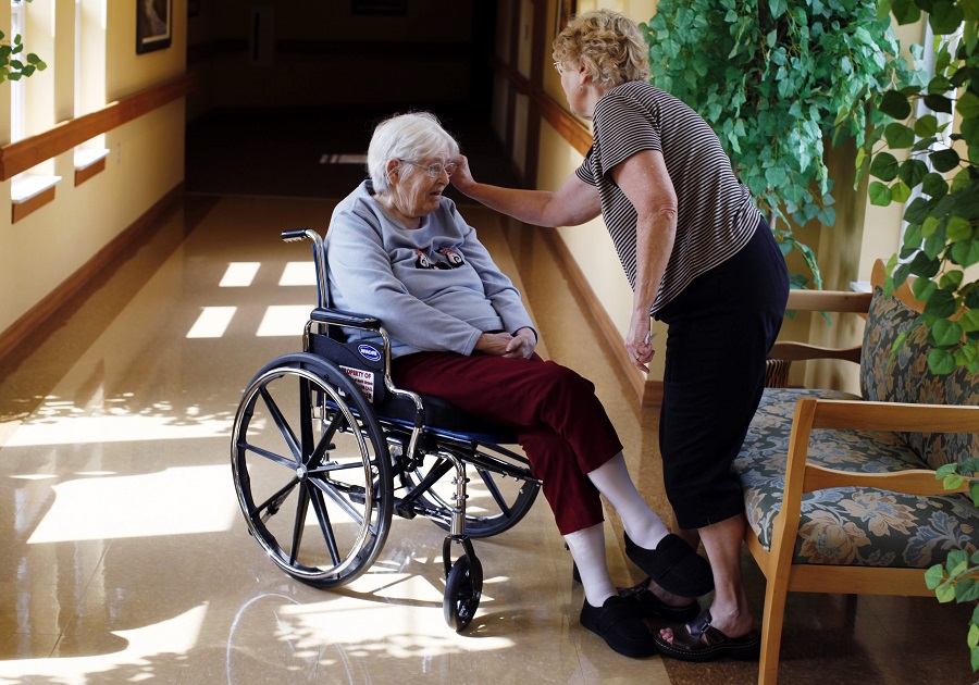 In this photo taken Aug. 13, 2011, Jean Lynch, right, spends time with her mother Hazel Eng, 89, at the Ecumen nursing home in North Branch, Minn.(AP Photo/Genevieve Ross) 