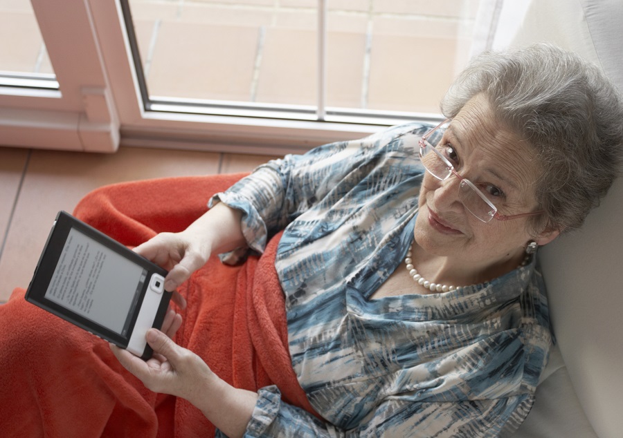 Older woman reading an e-book (Photo: Getty)