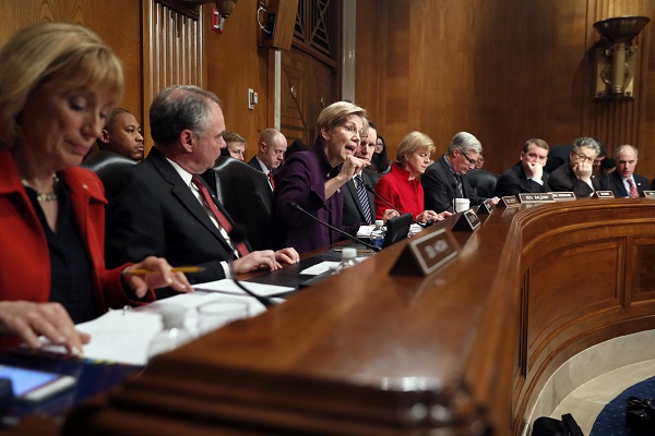 HELP Committee members at the hearing for Betsy DeVos, from left are, Sen. Maggie Hassan, D-N.H., Sen. Tim Kaine, D-Va., Warren, Sen. Christopher Murphy, D-Conn., Sen. Tammy Baldwin, D-Wis., Sen. Sheldon Whitehouse, D-R.I., Sen. Michael Bennet, D-Colo., Sen. Al Franken, D-Minn. and Sen. Robert Casey, D-Pa. (AP Photo/Alex Brandon)