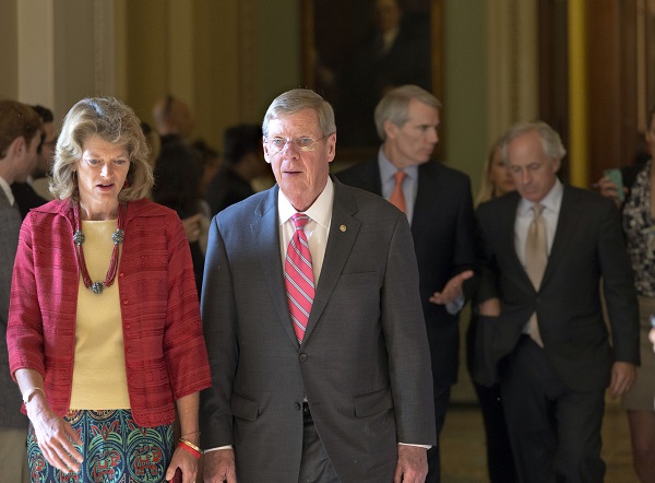 From left, Sen. Lisa Murkowski, R-Alaska, Sen. Johnny Isakson, R-Ga., Sen. Rob Portman, R-Ohio, and Sen. Bob Corker, R-Tenn., walk to a closed-door meeting in the Old Senate Chamber on July 15, 2013. (AP Photo/J. Scott Applewhite)