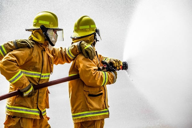 two firefighters with hose