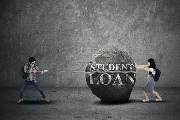 students pushing and pulling loan rock