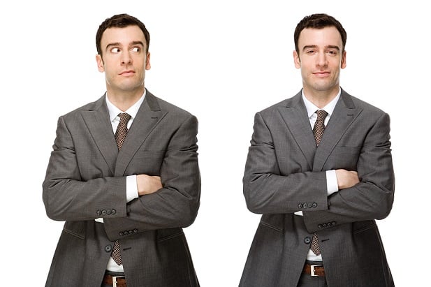 twin men in business suits, one unsure, other confident