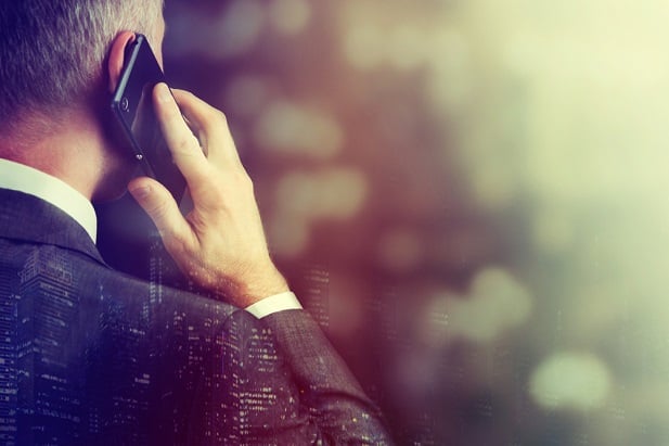 older business man talking on smartphone