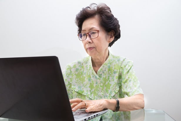 older woman using laptop