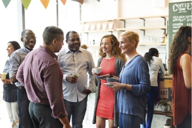 group of men and women standing at cocktail party