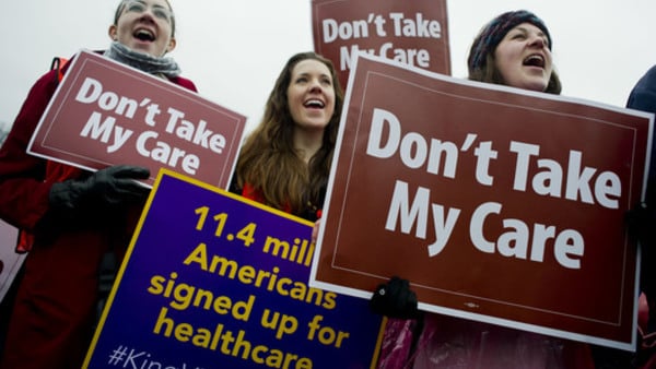 protestors holding signs say don't take my care