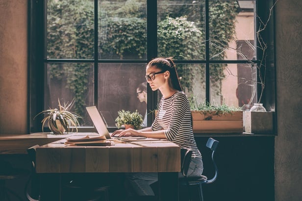 woman at home office next to window