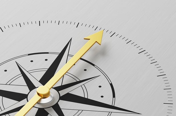 compass with golden arrow pointing in one direction