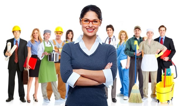 employees from white and blue collar jobs lined up behind young woman in sweater and glasses