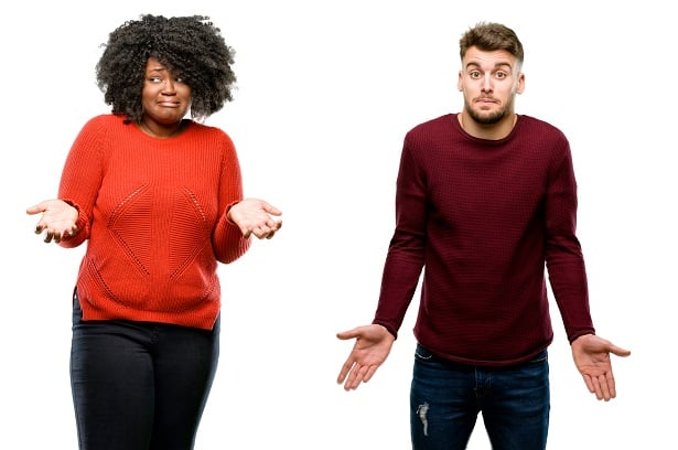 woman and man holding arms out to express confusion
